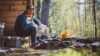 Man with a dog enjoying a bonfire